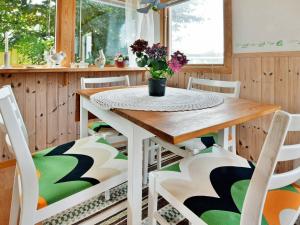 ファルケンベリにあるHoliday home in Falkenberg 1のダイニングルーム(花のテーブルと椅子付)