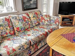 a living room with a couch and a table at 4 person holiday home in Lemvig in Trans