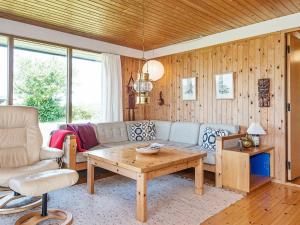 a living room with a couch and a table at 7 person holiday home in Knebel in Knebel