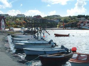 a group of boats are lined up on the water at Four-Bedroom Holiday home in Sirevåg in Sirevåg