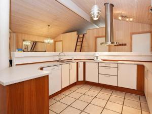cocina grande con armarios blancos y fregadero en 10 person holiday home in Gilleleje, en Gilleleje