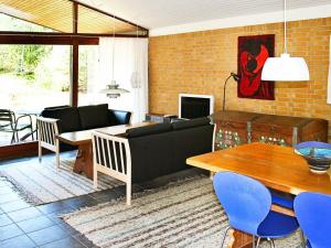 a living room with a couch and a table at 6 person holiday home in Nex in Spidsegård