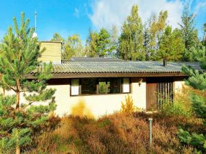 a house in the middle of a forest at 6 person holiday home in Nex in Spidsegård