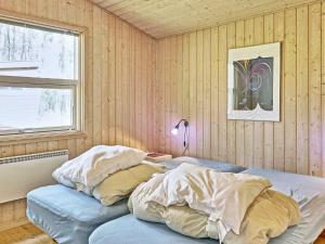 a bedroom with two beds and a window at Cozy Holiday Home in Aakirkeby Bornholm near the Sea in Vester Sømarken