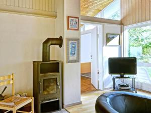 A television and/or entertainment centre at Three-Bedroom Holiday home in Aakirkeby 5