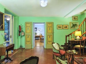 a living room with green walls and chairs at Belvilla by OYO Monti in Senigallia