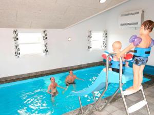 a group of children playing in a swimming pool at 20 person holiday home in L kken in Nørre Lyngby