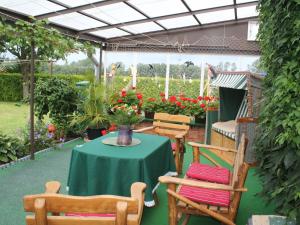 un patio con mesa, sillas y flores en Charming Apartment in Rerik with Fenced Garden, en Rerik