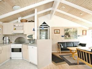 a kitchen and living room in a tiny house at 10 person holiday home in lb k in Skram