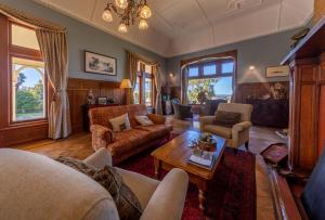 a living room with a couch and a table at Pen-y-bryn Lodge in Oamaru