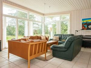 a living room with two couches and a piano at 6 person holiday home in Knebel in Knebel