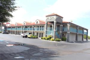 a large building with cars parked in a parking lot at Baymont by Wyndham Franklin in Franklin