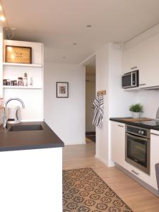 a kitchen with a sink and a counter top at ApartmentInCopenhagen Apartment 427 in Copenhagen