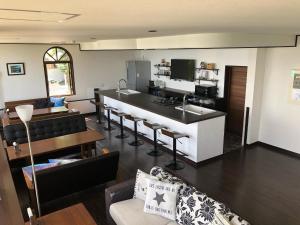 a living room with a kitchen and a living room with a counter at The Little Garden in Miyazaki
