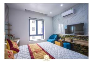 a bedroom with a bed and a flat screen tv at HM Hotel& Apartment in Hai Phong