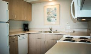 a kitchen with a sink and a stove top oven at The Beach Cottages in San Diego