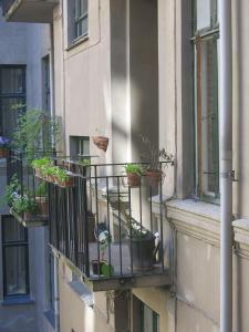 a balcony with potted plants on the side of a building at ApartmentInCopenhagen Apartment 1279 in Copenhagen
