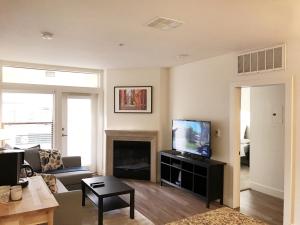 a living room with a couch and a television at Perfect Apt near UCLA w Parking Gym Pool WIFI in Westwood B3 in Los Angeles