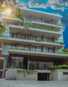 an apartment building with plants on the balconies at Nagomi Suites & Hotel in Jakarta