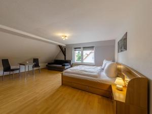 a bedroom with a bed and a table and a couch at De Doerpkieker in Torgelow am See