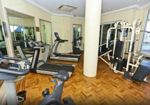 a gym with several treadmills and elliptical machines at Location Location Location - Broadbeach :) in Gold Coast