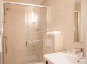 a bathroom with a shower and a sink at Hotel Sixteen Paris Montrouge in Montrouge