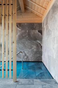 a swimming pool in a house with a wooden ceiling at Hotel Tyrol in Selva di Val Gardena