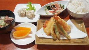 a table with plates of food on a table at 旅館いしのまき in Ishinomaki +15 photos