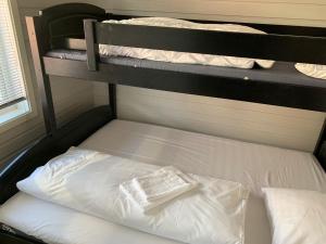 a bunk bed with two pillows on top of it at Garsnes Brygge in Sjøvegan