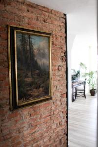 a painting of a forest on a brick wall at Boutique Hotel Krone München in Munich
