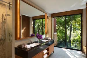 a bathroom with two sinks and a large mirror at Avani Ao Nang Cliff Krabi Resort in Ao Nang Beach