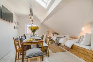 a dining room with a table and a couch at APTs in OLD TOWN PRAGUE by Michal&Friends in Prague