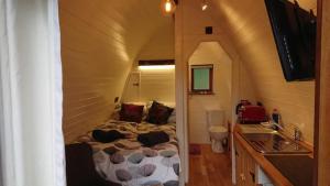 a bedroom with a bed in a small room at Owl Hut Cosy Ensuite Pod Snowdonia Coast Sleeps 2 in Dolgellau