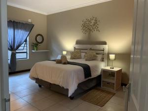 a bedroom with a large bed and a window at Bread & Barrel Eureka Kimberley in Kimberley