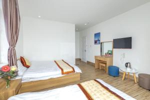 Postel nebo postele na pokoji v ubytování Lacami Dalat Hotel