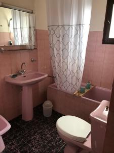 a bathroom with a sink and a toilet and a tub at Village vacances Le Savoy in Le Grand-Bornand