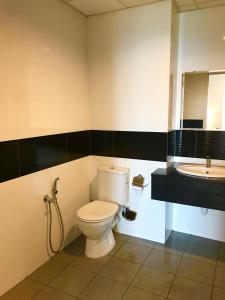 a bathroom with a toilet and a sink at Mansion One Suites by Little Cabin in George Town