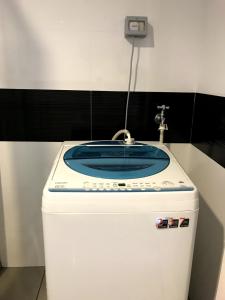 a bathroom with a sink on top of a refrigerator at Mansion One Suites by Little Cabin in George Town