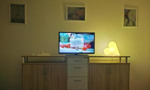 a flat screen tv sitting on top of a cabinet at Burgauer Fewo in Burgau