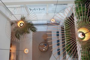 a window of a building with two fans at Hotel MiM Mallorca & Spa - Adults Only in Sa Coma