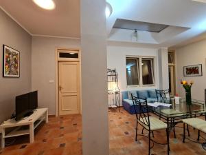 a living room with a table and a dining room at Apartmani N.May's in Karlovac