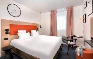 Hôtel ibis Styles Montargis Arboria tesisinde bir odada yatak veya yataklar