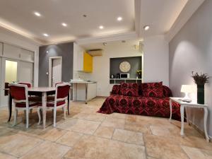 a living room with a red couch and a table at Apartmani N.May's in Karlovac
