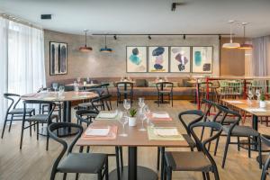 a restaurant with tables and chairs in a room at Barceló Costa Vasca in San Sebastián