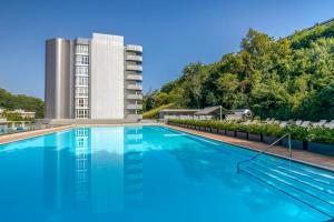 a large swimming pool in front of a building at Barceló Costa Vasca in San Sebastián