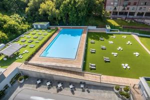 an overhead view of a large swimming pool on a lawn at Barceló Costa Vasca in San Sebastián