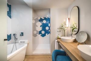 a bathroom with a tub and a sink and a tubermott at Barceló Costa Vasca in San Sebastián