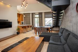 a living room with a couch and a table at Luxury 4 bedroom apartment #1 in the city center of tbilisi in Tbilisi City