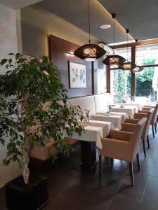 une rangée de tables et de chaises dans un restaurant dans l'établissement LONDON Boutique hotel & Restaurant, à Trnava