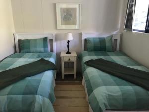 two beds sitting next to each other in a room at Santos 27 Mossel Bay in Mossel Bay